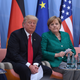 Trump, having no goddamned clue, with German Chancellor Angela Merkel (Photo: Patrik Stollarz/ Getty Images)